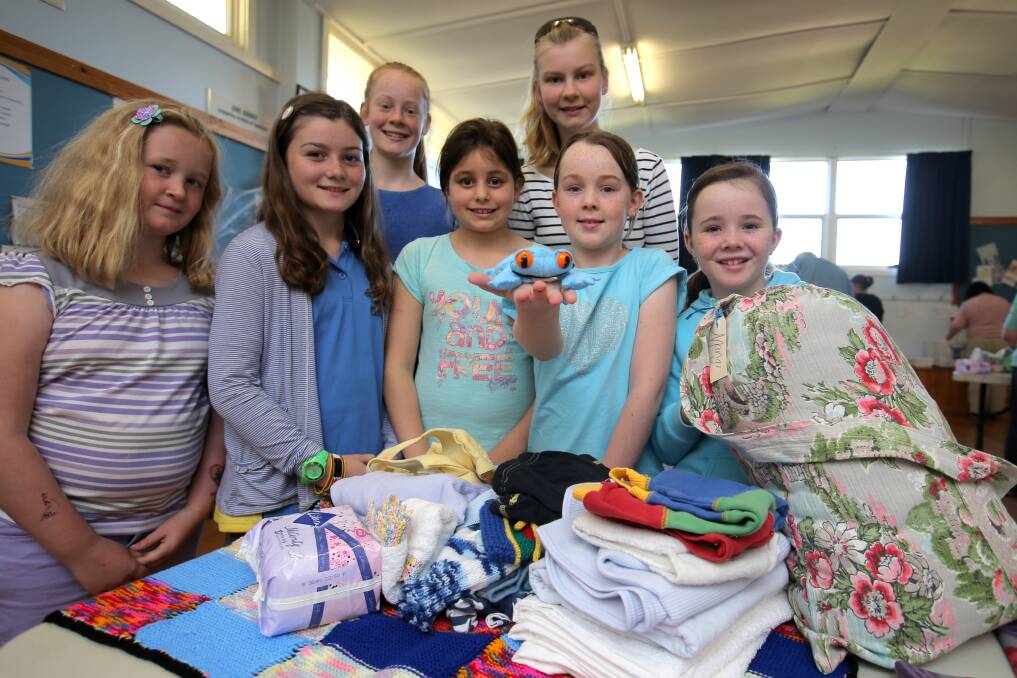 Warrnambool Guides Sophie Mack, 10, Ruby Bilson, 11, Maggie Rayner, 11, Isabel Henderson, 9, Bronte Rayner, 14, Anastasia Rea, 10, and Courtney Rea, 8, are packing donated mother and baby products which will be shipped to the Papua New Guinea highlands. Picture: ROB GUNSTONE