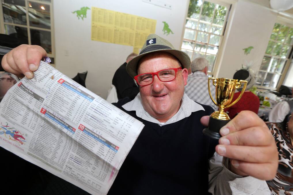 Shane Morris holds the cup he won at the Port Fairy Senior Citizen Cup Eve Sweep. 